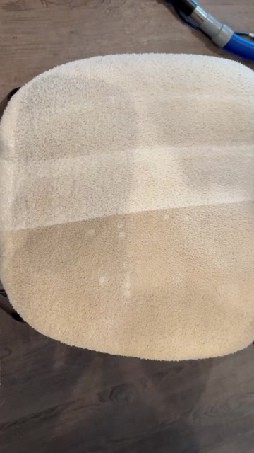 A barstool seat being cleaned, showing a clear line between the dirty and freshly cleaned half