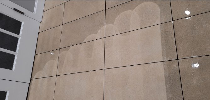 Large-format tile floor mid-clean — wand passes lifting built-up soil