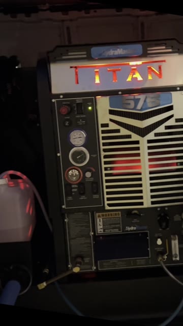 The truck-mounted HydraMaster Titan 575 carpet-cleaning machine glowing at night